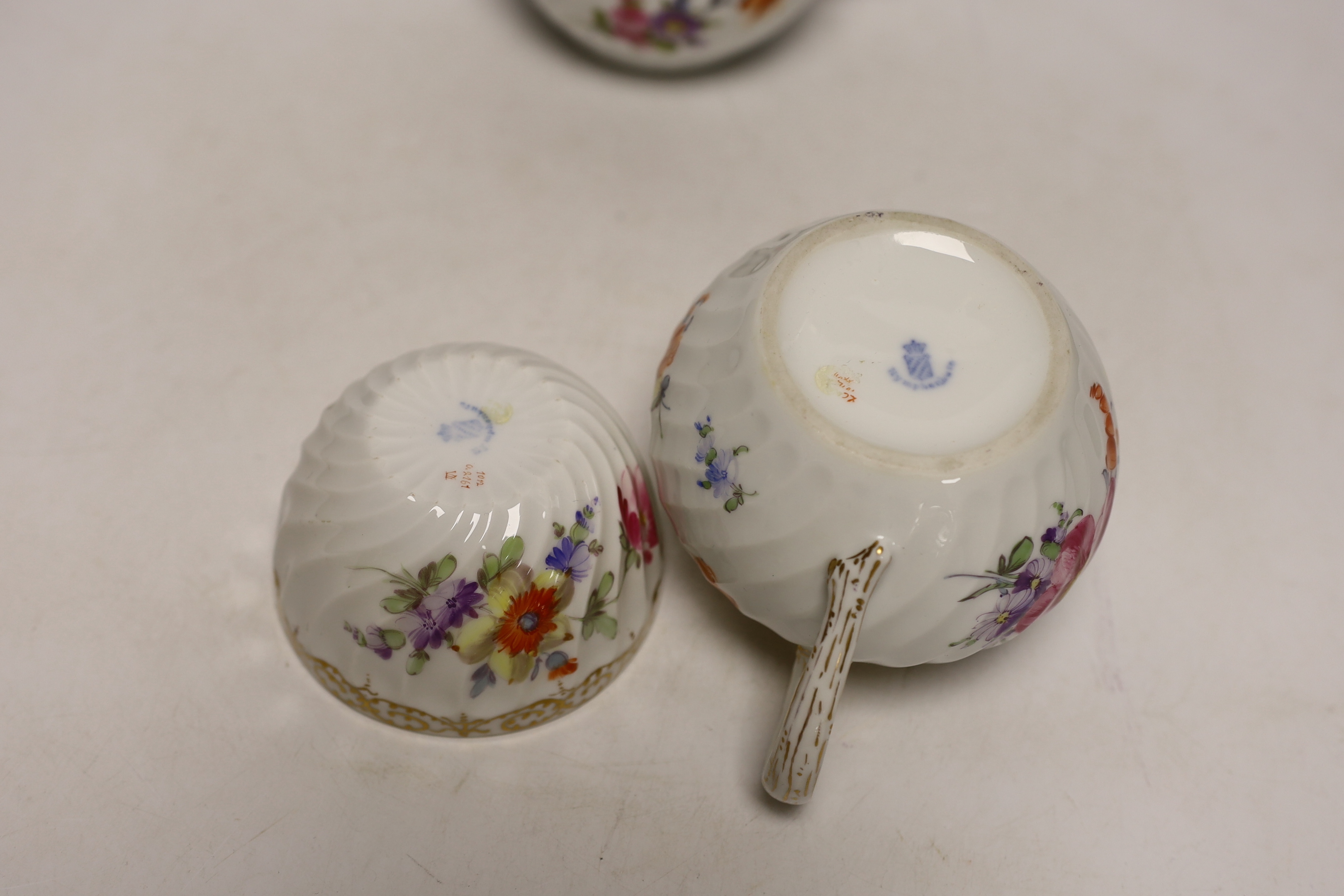 A Nymphenburg floral decorated teapot, milk jug and sugar bowl, teapot 13c high